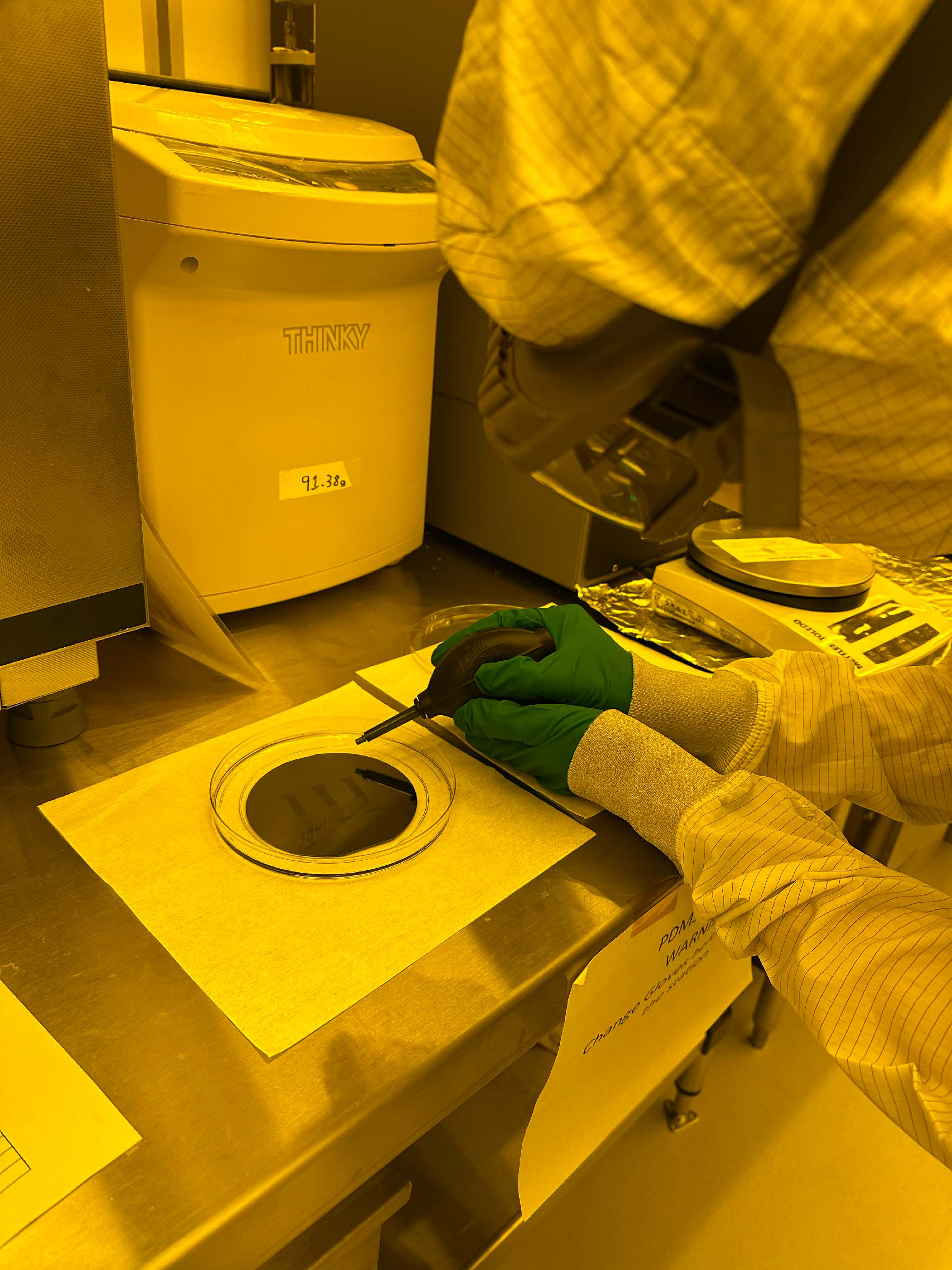Researcher handling a wafer in the cleanroom